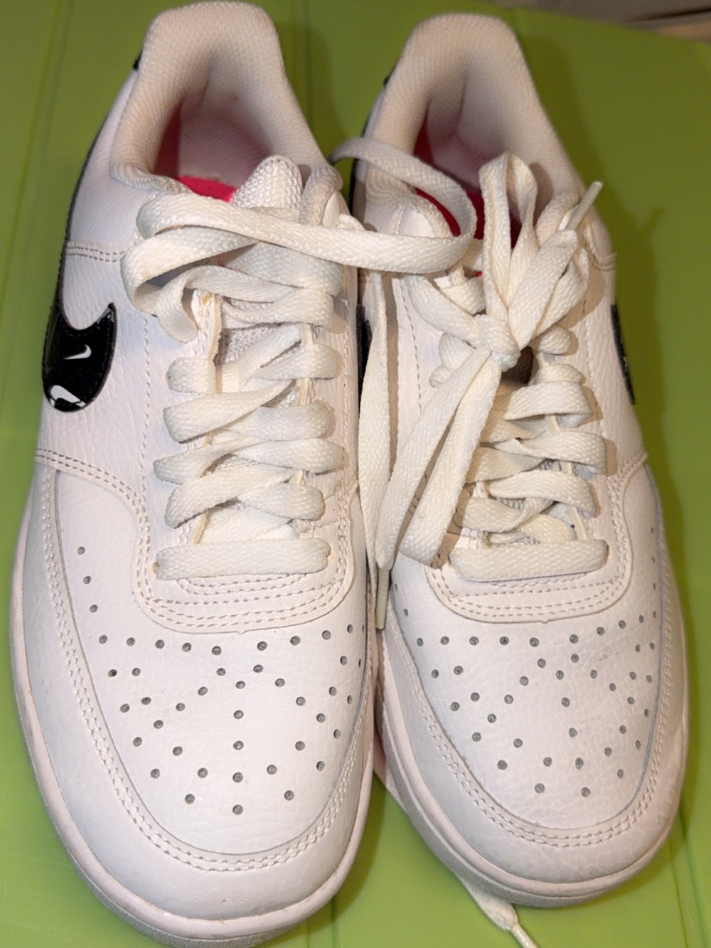 Nike Men's White Leather Athletic Sneakers with Black Swoosh and Pink Accent
